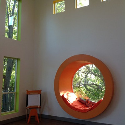 Huge minimalist gender-neutral dark wood floor playroom photo in Boston