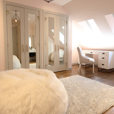 Example of a mid-sized minimalist girl dark wood floor and brown floor kids' room design in Calgary with pink walls