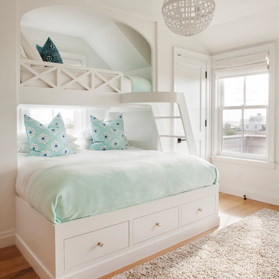 Kids' room - coastal girl light wood floor and beige floor kids' room idea in Boston with white walls