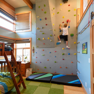 Ispirazione per una cameretta per bambini design con pavimento in legno massello medio e pareti blu
