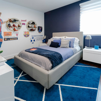 Inspiration for a mid-sized contemporary boy medium tone wood floor and brown floor kids' room remodel in Miami with blue walls