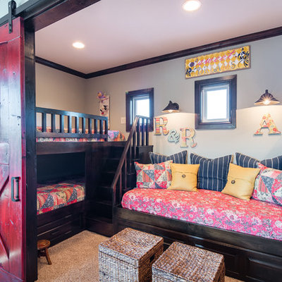 Example of a mountain style girl carpeted kids' room design in Austin with gray walls