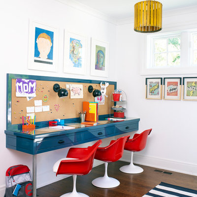Example of a trendy gender-neutral dark wood floor and brown floor kids' study room design in New York with white walls