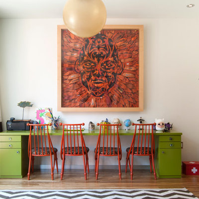 Large trendy gender-neutral medium tone wood floor kids' room photo in New York with white walls