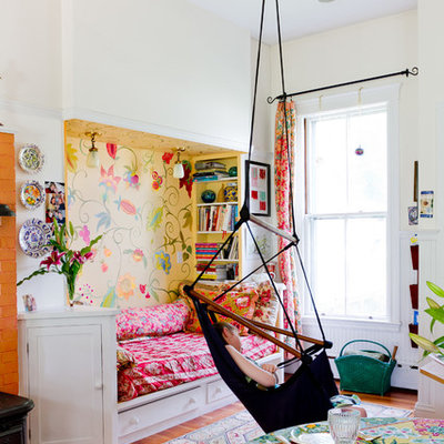 Eclectic girl medium tone wood floor kids' room photo in Boston with multicolored walls