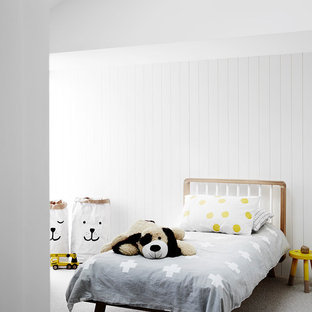 This is an example of a scandinavian gender-neutral kids' room in Melbourne with white walls, carpet and grey floor.