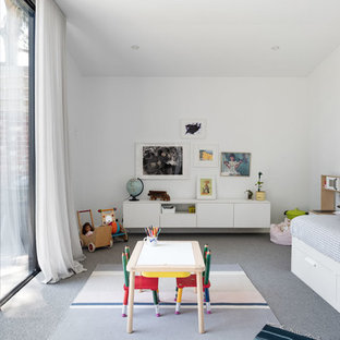 Mid-sized contemporary gender-neutral kids' playroom in Melbourne with white walls, carpet and grey floor for kids 4-10 years old.