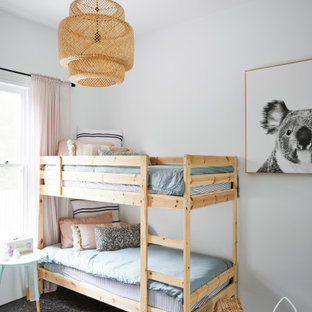 Inspiration for a mid-sized scandinavian kids' bedroom for boys in Other with white walls, concrete floors and grey floor.