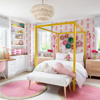 Example of a large transitional girl light wood floor and beige floor kids' room design in New York with pink walls