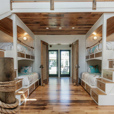 Inspiration for a coastal medium tone wood floor and brown floor kids' bedroom remodel in Boston with white walls