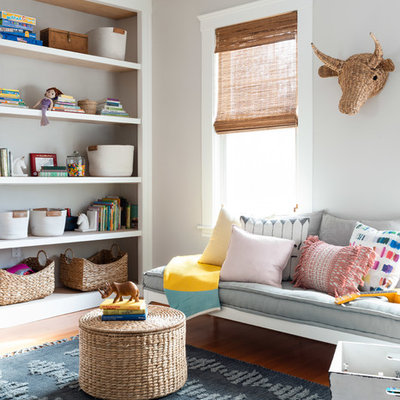 Kids' room - mid-sized contemporary gender-neutral medium tone wood floor and brown floor kids' room idea in Boston with gray walls