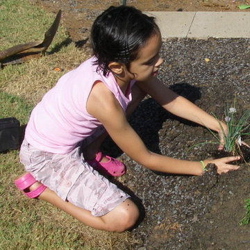 Planting in her own organic veggie and herb garden