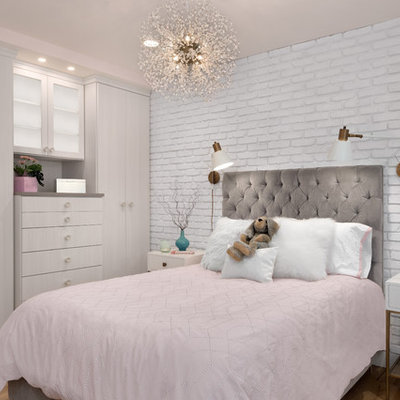 Example of a small trendy girl light wood floor and brown floor kids' room design in Seattle with pink walls