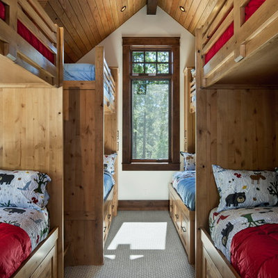 Example of a mid-sized mountain style gender-neutral carpeted and multicolored floor kids' room design in Sacramento with white walls