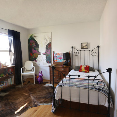 Inspiration for an eclectic gender-neutral medium tone wood floor kids' room remodel in San Diego with white walls