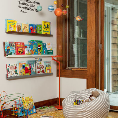 Transitional gender-neutral medium tone wood floor and brown floor playroom photo in Other with white walls