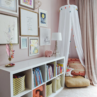 Inspiration for a mid-sized transitional girl carpeted and beige floor kids' room remodel in Other with pink walls