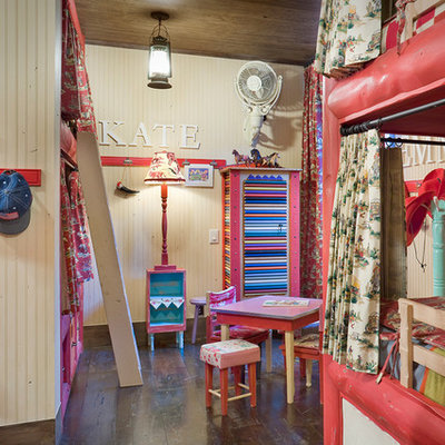 Mountain style girl dark wood floor kids' room photo in Denver with beige walls