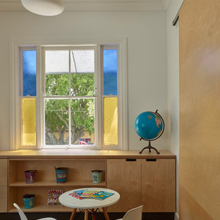 Photo of a contemporary gender-neutral kids' playroom in Brisbane with white walls, medium hardwood floors and brown floor.