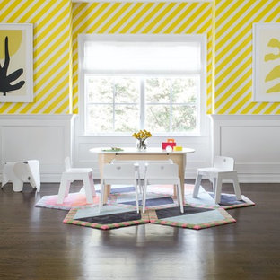 Example of a huge transitional gender-neutral dark wood floor and brown floor kids' room design in New York with yellow walls