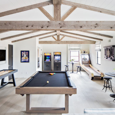 Example of a huge tuscan gender-neutral light wood floor and beige floor kids' room design in San Diego with white walls