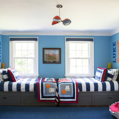 Large transitional boy dark wood floor kids' room photo in New York with blue walls