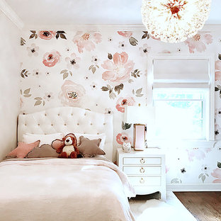 Kids' room - traditional girl brown floor, wallpaper and dark wood floor kids' room idea in New York with pink walls