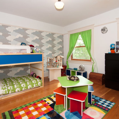 Kids' room - contemporary gender-neutral medium tone wood floor kids' room idea in Portland with white walls