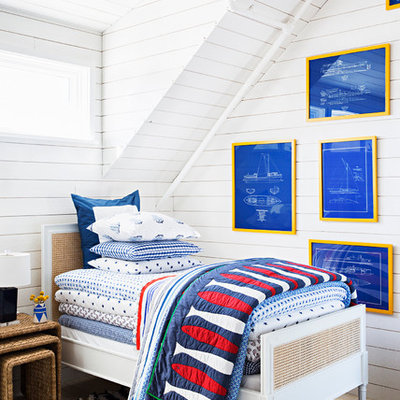 Mid-sized beach style boy light wood floor kids' bedroom photo in New York with white walls