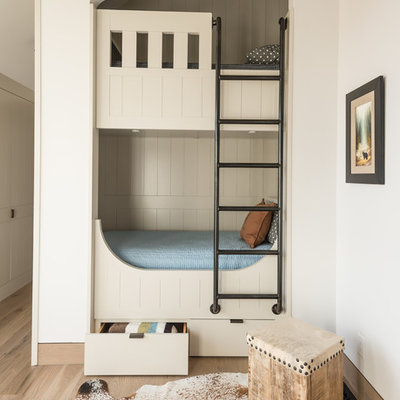 Transitional gender-neutral light wood floor and beige floor kids' bedroom photo in Other with white walls