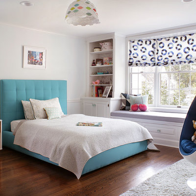 Example of a mid-sized transitional gender-neutral dark wood floor kids' room design in New York with white walls