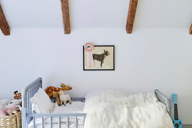 Example of a farmhouse painted wood floor and white floor kids' bedroom design in New York with white walls