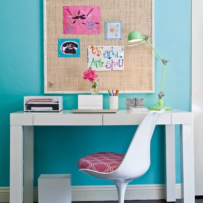 Trendy girl dark wood floor kids' room photo in Los Angeles with blue walls
