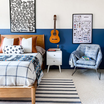 Example of a mid-sized transitional boy carpeted and beige floor kids' room design in Dallas with blue walls