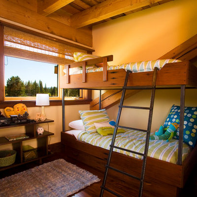 Mountain style gender-neutral dark wood floor kids' room photo in Sacramento with yellow walls
