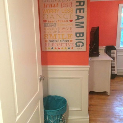 Small minimalist girl kids' bedroom photo in New York with orange walls