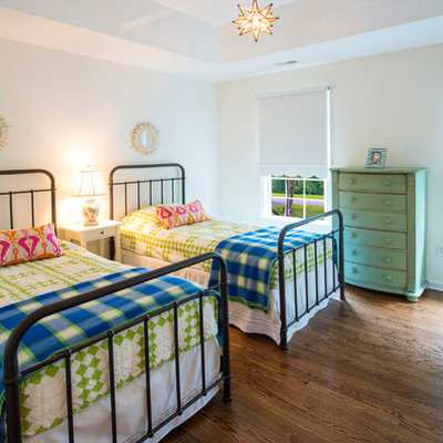 Example of a classic gender-neutral medium tone wood floor kids' room design in Baltimore with white walls