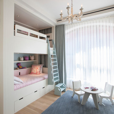 Kids' room - mid-sized transitional girl light wood floor kids' room idea in New York with white walls