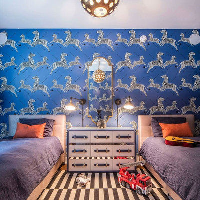 Inspiration for a mid-sized transitional boy medium tone wood floor and brown floor kids' room remodel in New York with blue walls