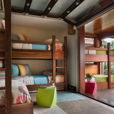 Example of a mid-sized beach style gender-neutral dark wood floor kids' room design in Boston with beige walls