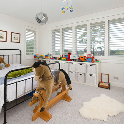 Kids' room - large transitional gender-neutral carpeted kids' room idea in Sydney with white walls