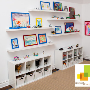 Example of a mid-sized minimalist gender-neutral kids' room design in New York with white walls
