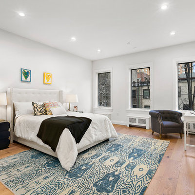 Kids' room - transitional girl medium tone wood floor kids' room idea in New York with white walls