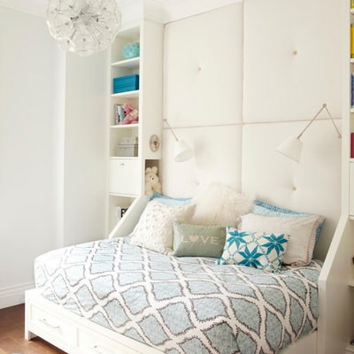 Inspiration for a mid-sized transitional girl medium tone wood floor kids' room remodel in New York with white walls