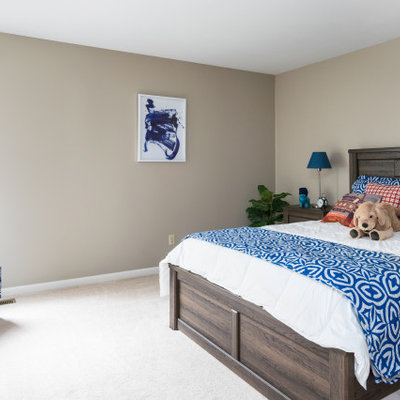 Example of a large transitional boy carpeted and white floor kids' room design in St Louis with brown walls