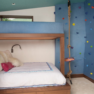 This is an example of a mid-sized contemporary kids' bedroom in Denver with blue walls, carpet and beige floor.
