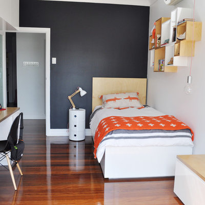 Kids' room - mid-sized contemporary boy medium tone wood floor kids' room idea in Brisbane with black walls