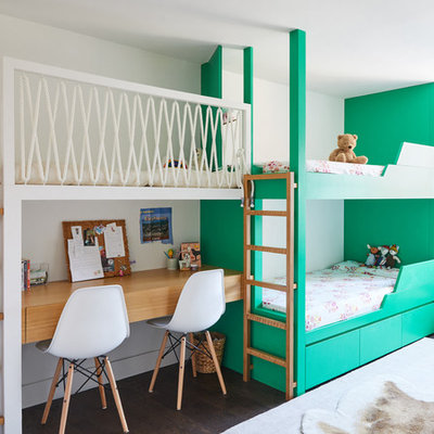 Example of a trendy gender-neutral dark wood floor and brown floor kids' bedroom design in New York with white walls