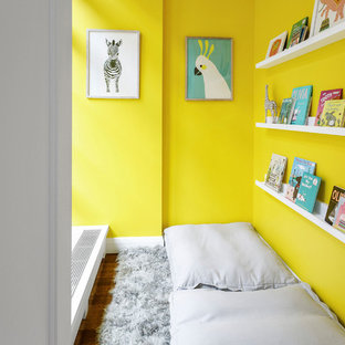 Example of a trendy dark wood floor and brown floor playroom design in Miami with yellow walls