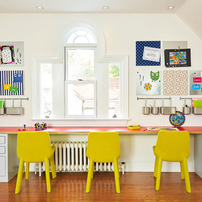 Transitional gender-neutral medium tone wood floor kids' room photo in Wilmington with beige walls